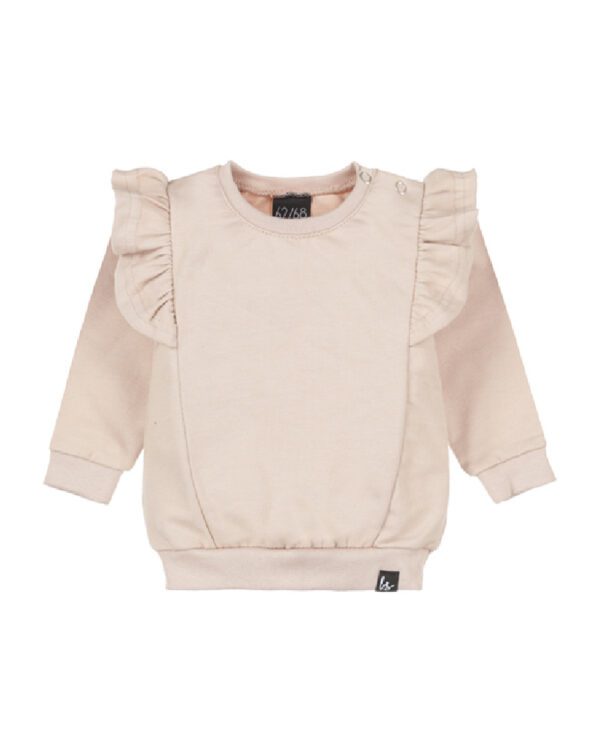 Babystyling Ruffle Sweater kaunis vauvan paita, sävy Soft Beige Tyylikkäässä paidassa on kauniit röyhelöyksityiskohat. Pääntiessä on kaksi nepparia, jotta paita on helppo pukea päälle. Hihansuissa on resorit, jotka antavat paidalle lisää käyttöikää.
